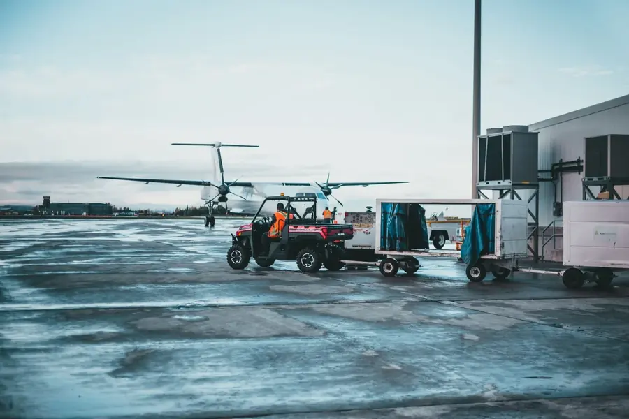 Ground vehicles and an aircraft on an airport apron