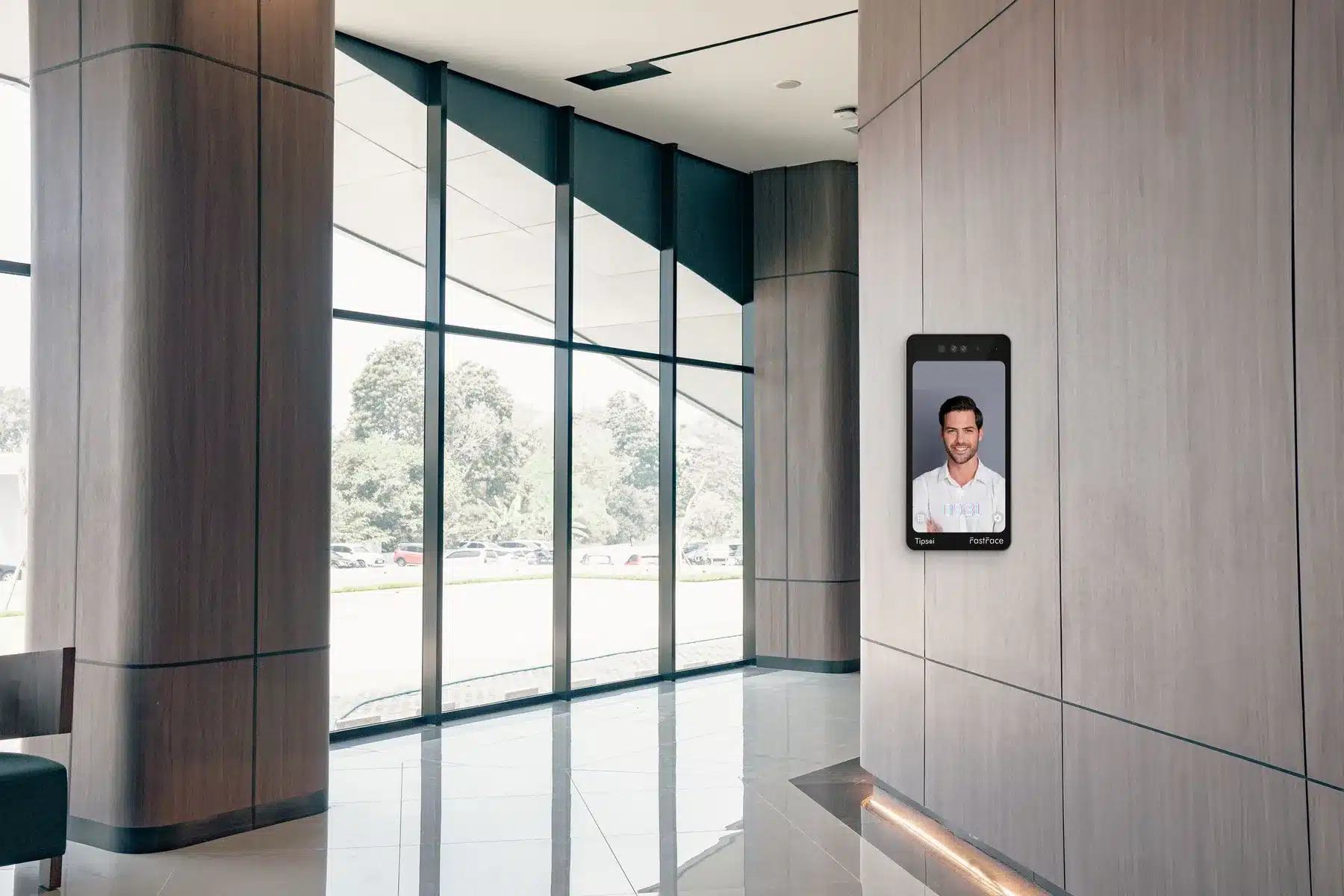 A Tipsoi FastFace 8 reader on the wall beside a lobby entrance