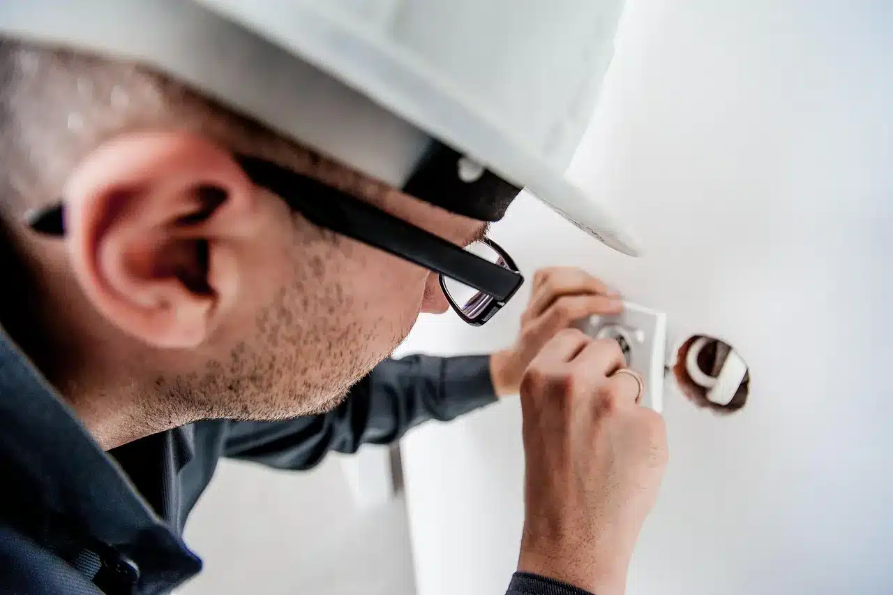 A technician fitting a reader at a door